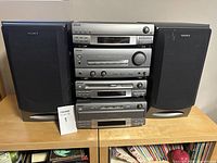 Full front view of Sony DHC-MD7 stereo system with components stacked and speakers on each side.