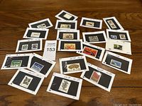 Overview of multiple mounted Chinese postage stamps spread on table