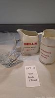 Photo of three bar items including a clear glass mug and two ceramic jugs with Scotch Whisky branding