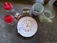 Photo of all items including clock, vases, figurines, calendar, canisters