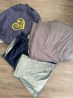 Allike weighted blanket folded with removable dual-sided cover in navy blue and grey shown alongside branded storage bag.