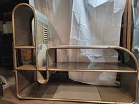 Full frontal view showing two-tier design, left curved arch side and right low shelf