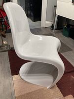 Front-left angle showing S-curve shape and integrated base.