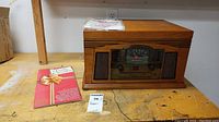 Photo of the Crosley stereo system along with a Reader's Digest Music Christmas CD case next to it on a wooden surface
