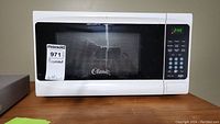 Front view of white Classic microwave oven with digital keypad and display showing 2:49