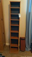 Front view of tall free-standing laminate shelving unit showing multiple adjustable shelves