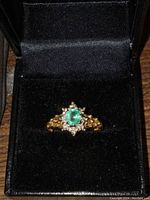Ring displayed in black velvet presentation box showing full top view