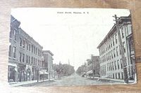 Front side photo showing street view on James Street, Clayton, NY with buildings lining the road