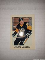 Front side of 1987 O-Pee-Chee Mario Lemieux hockey card showing player image and branding.