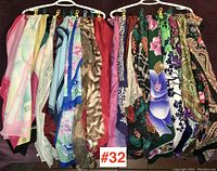 Wide view showing the full assortment of scarves hung on two racks with clips, reflecting the variety of colors and patterns.