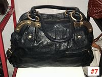 Front view of B. Makowsky black leather handbag showing texture and hardware