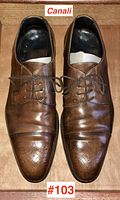 Top view of both brown leather dress shoes showing lace-up front and perforated brogue detailing on toe caps with Canali branding.