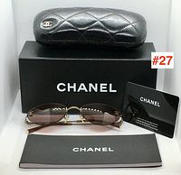 Sunglasses with packaging: hard case, soft pouch, box, authenticity card, booklet and sunglasses displayed