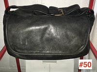 Front view of black leather Mario Galassi cross-body bag showing soft leather body and buckle on shoulder strap