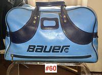 Front view of blue and black vintage Bauer sports bag with logo and handle in good condition.