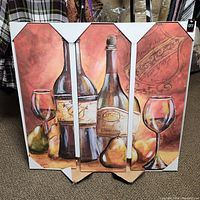 Full view of the three-panel wine and bar themed art piece in original packaging showing wine bottles, glasses, and pears in an earth-toned painterly style.