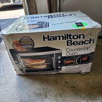 Front side of the Hamilton Beach countertop oven box showing model with rotisserie and convection features.