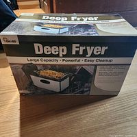 Closed box of the Chard deep fryer showing brand, key features such as large capacity and stainless steel material.