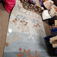 Full view of the large rectangular decorative rug showing leaf pattern and color.