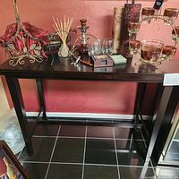 Wooden sofa table with dark finish, shown with bar items on top for scale but not included in sale.