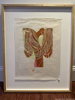 Framed abstract art print with warm earth tone flowing patterns resembling a tree, signed by artist.