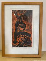 Framed limited edition print "Hex" showing two stylized figures in black and orange, signed and numbered by artist Trevers.