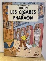 Plaque mount of Tintin Les Cigares du Pharaon showing Tintin and Snowy in Egyptian tomb with mummies encased in sarcophagi.