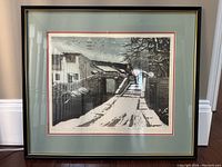 Framed limited edition Chinese art print showing a winter village scene with snow over a bridge and traditional buildings.