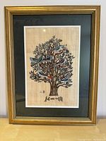 Full view of framed Tree of Life artwork with birds, gold frame and green mat