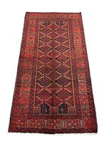 Full view of Persian Baluch handwoven rug showing geometric patterns and color palette.