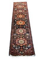 Full view of the entire Persian Bidjar runner rug showing the six floral medallions and border detail.