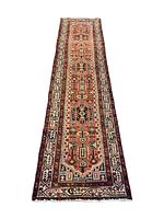 Full-length view of runner rug on white background showing overall geometric design and borders