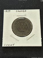 Reverse side of the 1859 Canada large one cent coin showing the denomination and date with a wreath design.
