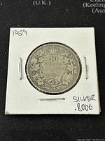 Reverse side of 1929 Canadian 50 cents silver coin showing denomination and maple leaf wreath design with date 1929.