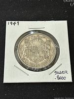 Obverse side of the 1949 Canadian 50 cents coin showing the crowned shield with '50 CENTS CANADA 1949'.