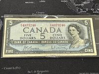 Front side of the 1954 Canadian five-dollar banknote showing portrait of Queen Elizabeth II and serial number.