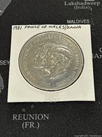 Front side of 1981 coin showing dual profile portrait of Prince Charles and Lady Diana Spencer with inscriptions