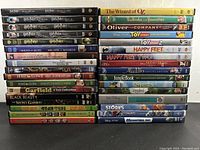 Stack of DVDs including Harry Potter series, Disney movies like Toy Story series, Aladdin, and others.