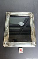 Top view of the large rectangular sterling silver photo frame with glass front; shows frame design and label inside.