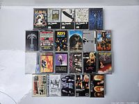 Photo showing entire collection of 20 vintage hard rock cassette tapes arranged in rows. Bands include Led Zeppelin, KISS, Guns N' Roses, Lita Ford, Mötley Crüe, among others.