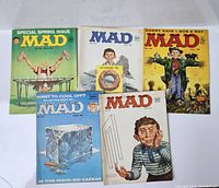 Overview of 5 vintage MAD magazines from the 1950s, showing front covers with varied artwork featuring Alfred E. Neuman.