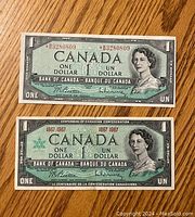 Front sides of two vintage Canadian $1 bills, one regular and one Centennial edition with 1867-1967 dates, both bearing Queen Elizabeth II's portrait