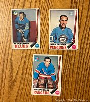Front view of the three hockey cards featuring players AB McDonald, Dean Prentice, and Ed Giacomin.