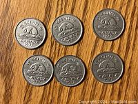 Six 1937 Canadian 5 cent nickels showing the reverse side featuring a beaver and the denomination.