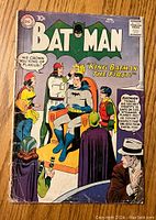 Front cover of Batman #125 comic book showing Batman crowned as 'King Batman The First' with multiple characters around him and visible signs of wear and repair staples.
