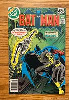 Front cover of Batman #311 comic book showing Batman, Batgirl, and Dr. Phosphorus with colorful illustrated cover art.