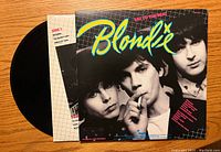Blondie vinyl record with cover sleeve for 'Eat to the Beat' album featuring band members' black-and-white photo with colorful Blondie text.