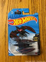 Front view of new sealed Hot Wheels Batman Batplane toy in original packaging