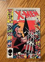 Front cover of The Uncanny X-Men #211 comic book showing Wolverine with extended claws and multiple X-Men characters in border frames.