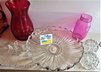 Full lot showing red vase, pink jar, clear sandwich plate, star candle holder, and two round Princess House candle holders on a white surface with ruler for size reference.